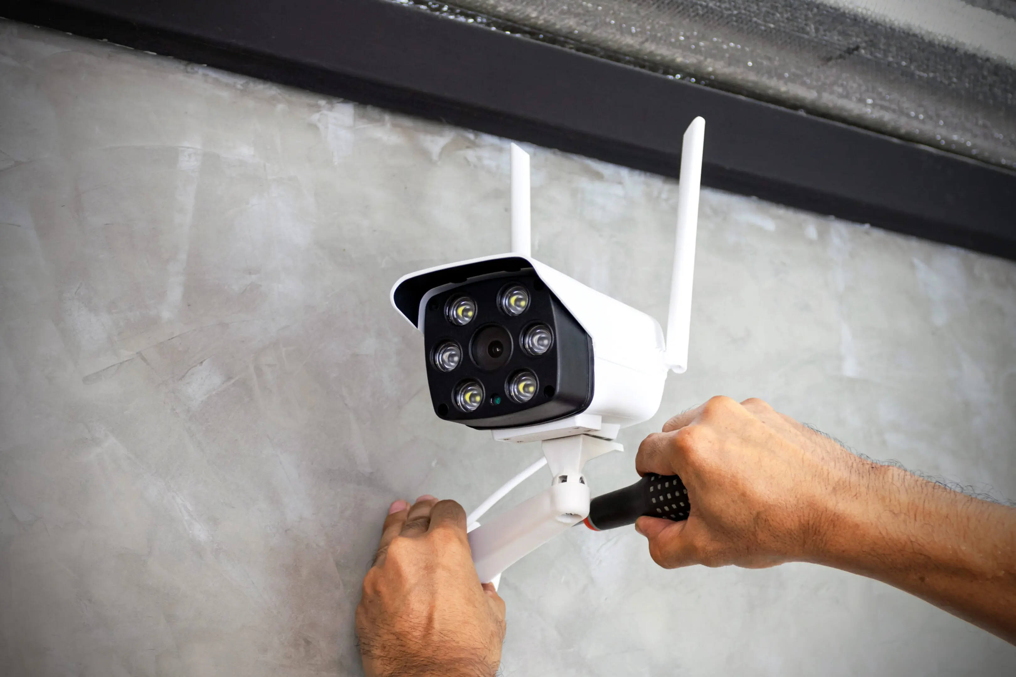 technician-installing-wireless-cctv-camera-wall